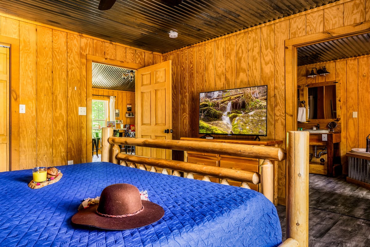 Bedroom 1 — King Bed with Smart TV & Log Frame